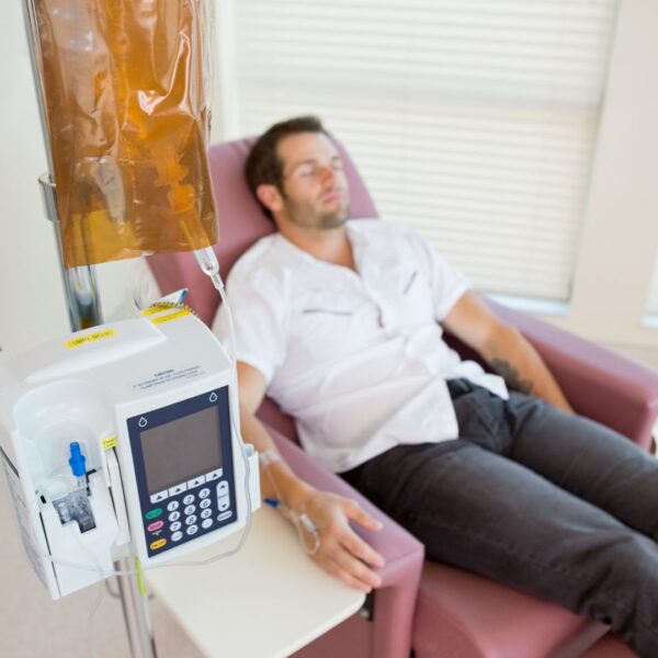 Man sitting on chair getting IV Therapy