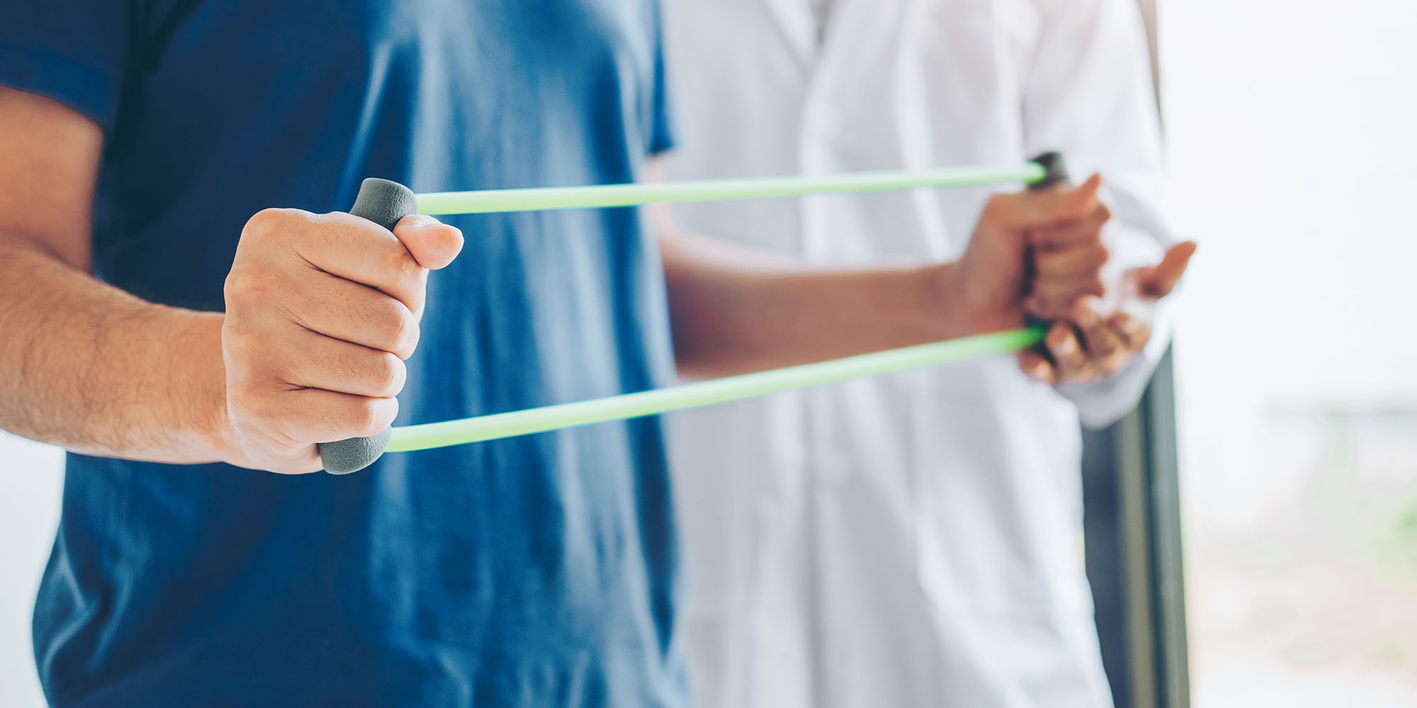 Someone using bands to stretch their chest