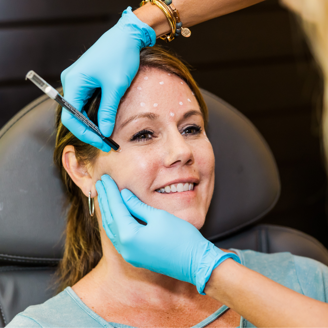 woman getting marked before receiving her cosmetic injectable treatment