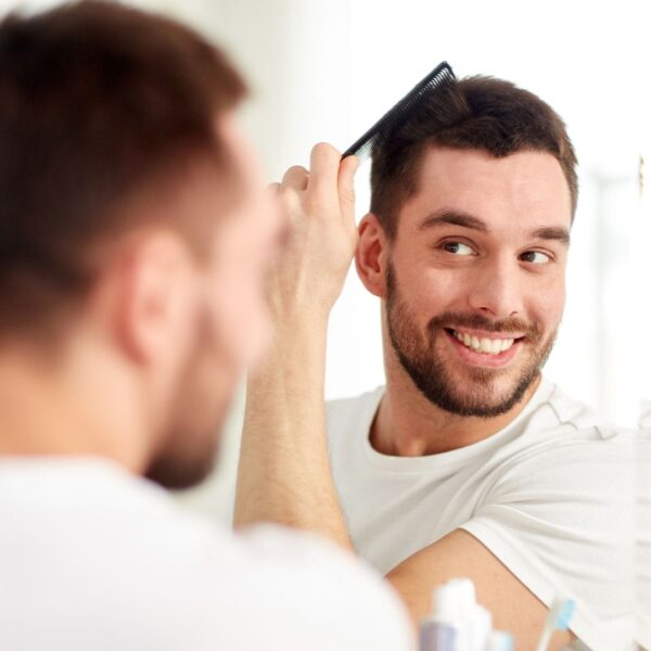 img of a man combing his hair