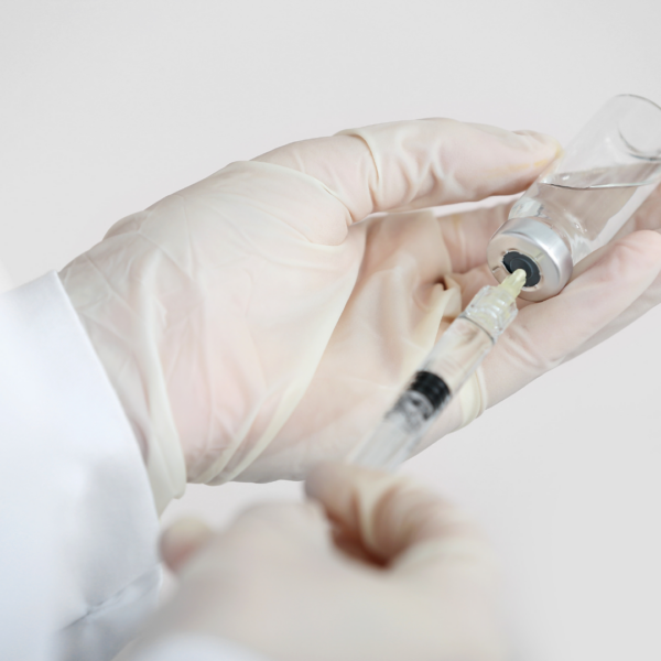 Filler being pulled into a syringe.