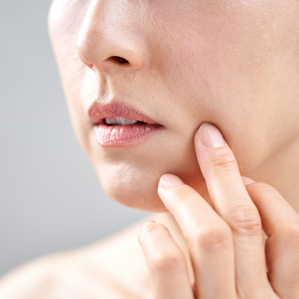 Woman looking at her face in the mirror