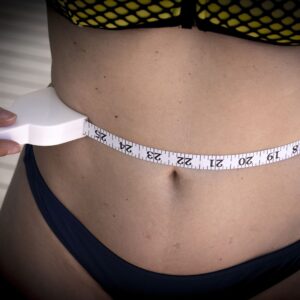 woman measuring waist