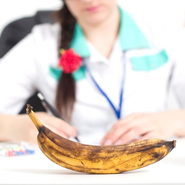 Doctor in front of a banana