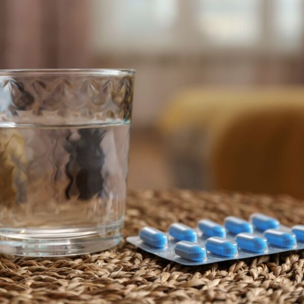 Glass of water and medication for ED