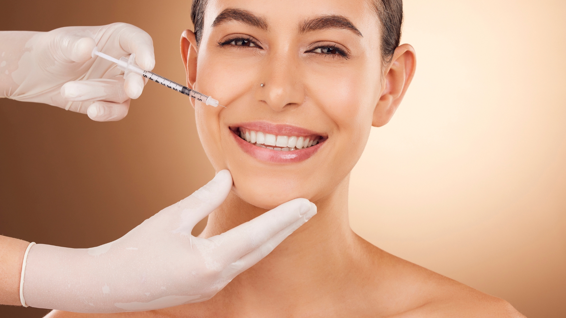 Smiling woman receiving facial filler