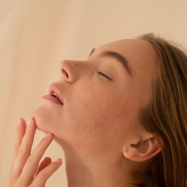 a woman touching her chin