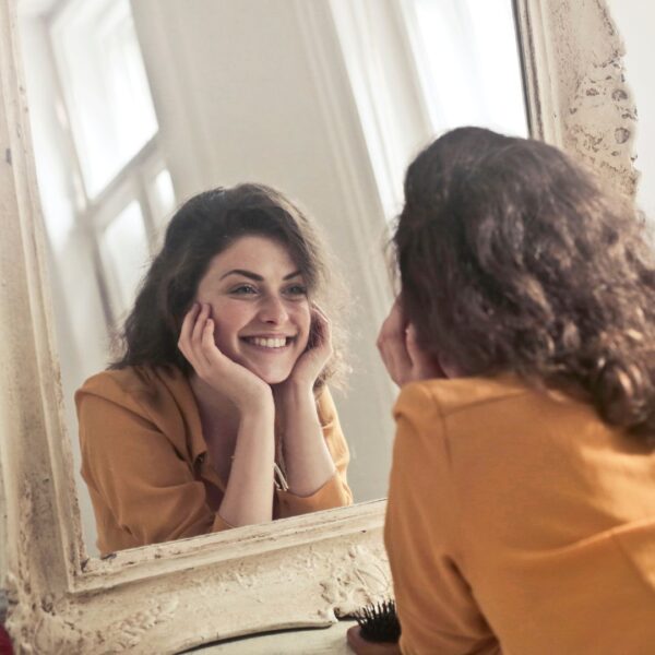 a woman smiling in a mirror