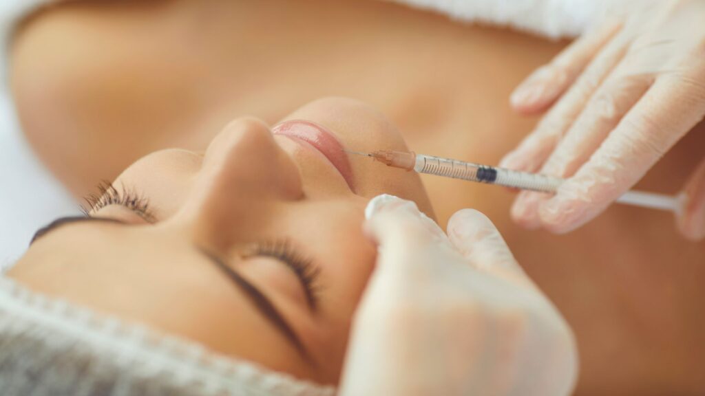 injecting botox into patient's chin