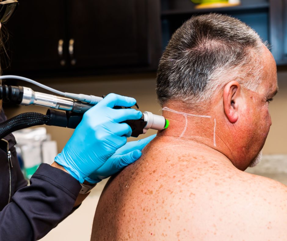 man receiving laser hair removal on neck