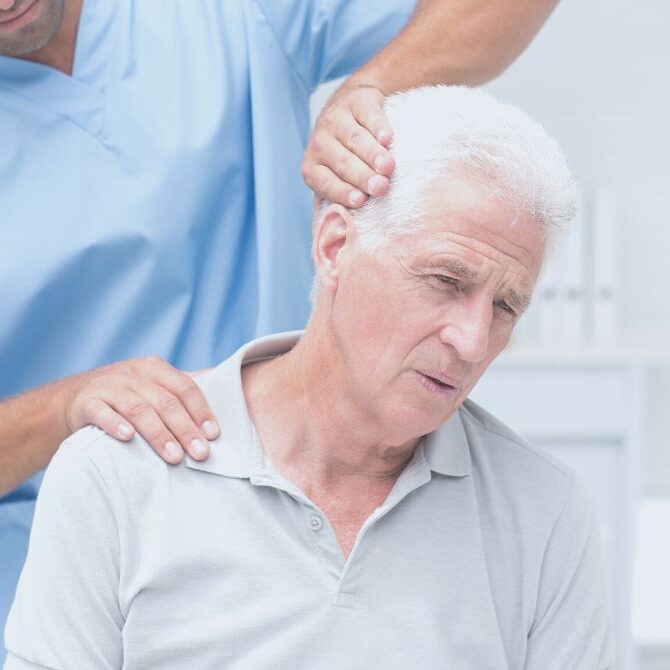 chiropractor diagnosing neck pain