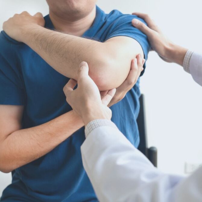 chiropractor working on elbow