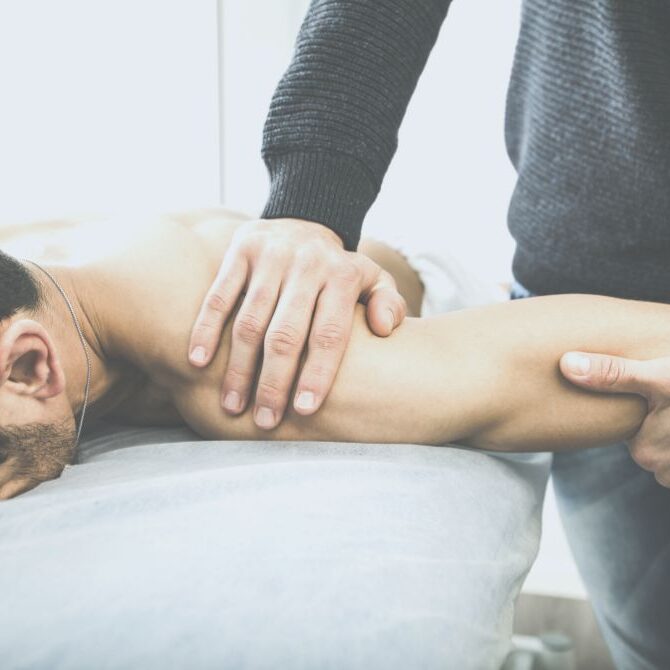 chiropractor working on shoulder